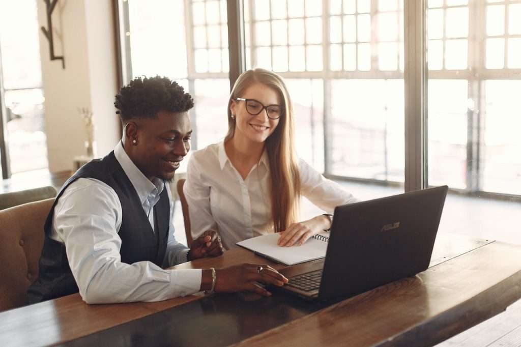 guy and a girl working together on a asus laptop