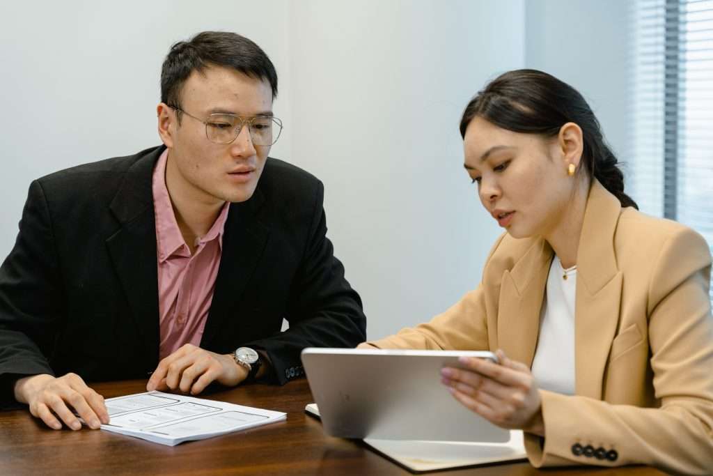 man and woman looking at the tablet