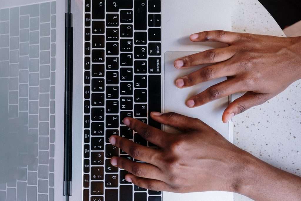 persons hand on macbook pro