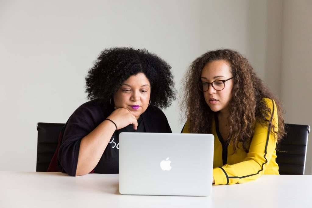 Two women looking at laptop