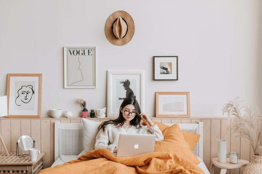 women using laptop in bed