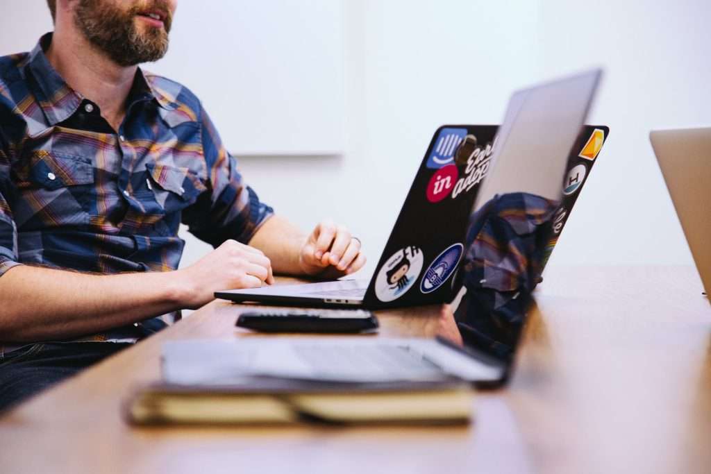 man sitting on front of laptop