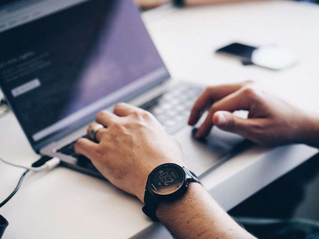 man using laptop for typing