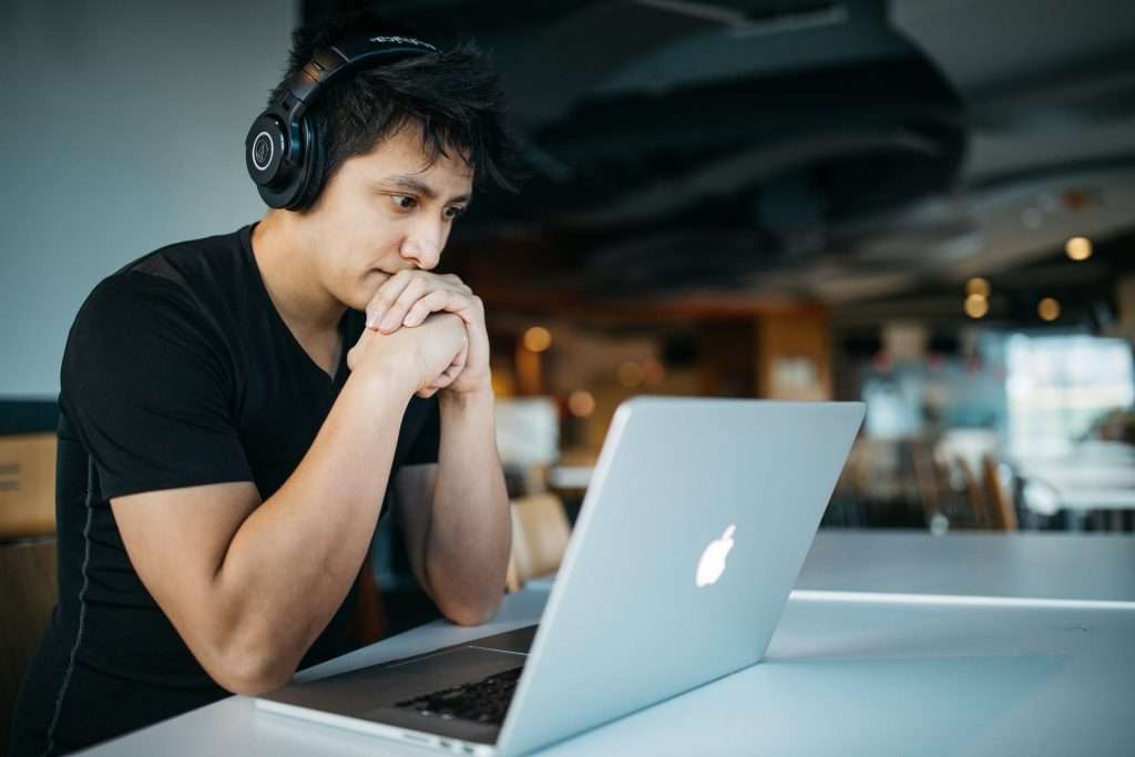 serious man looking at laptop