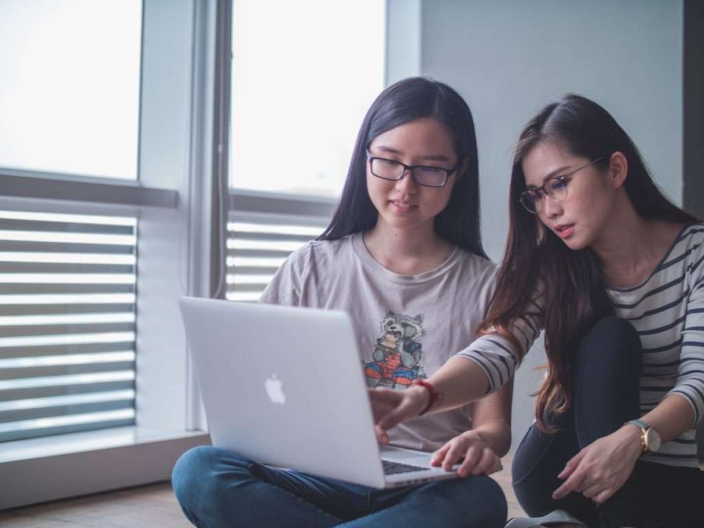 Two girls looking at laptop