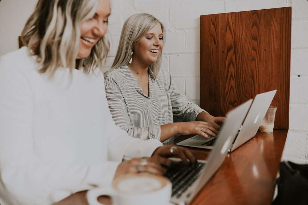 Women working together with laptops